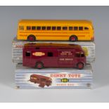 A Dinky Toys No. 981 horse box and a No. 949 Wayne school bus, both within blue and white striped