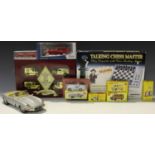 A collection of die-cast vehicles, including Atlas Dinky Toys vehicles, a Bburago E type Jaguar