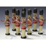 A set of eight painted wooden skittles in the form of soldiers blowing trumpets, height 18.5cm (