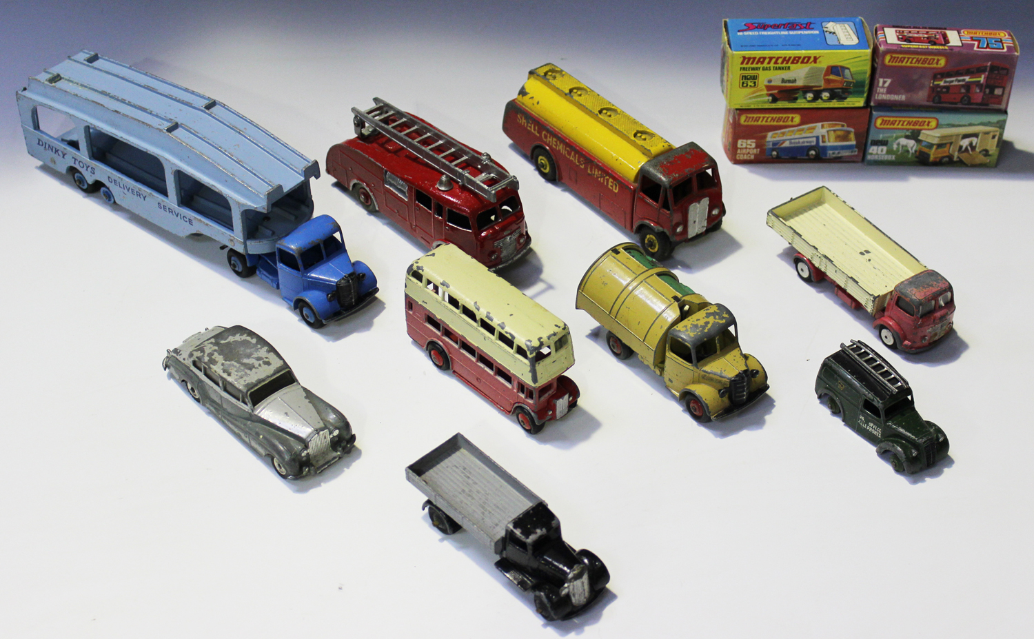 A small collection of Dinky Toys vehicles, including a No. 582 Pullmore car transporter, a No. 25a
