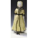 A Victorian Parian head and shoulders doll with painted moulded features and porcelain lower