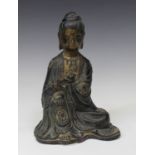 A Chinese Ming style bronze figure of a seated bodhisattva, Qing dynasty, modelled seated holding