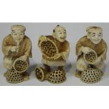 A group of three Japanese carved and stained ivory okimono netsuke, Meiji/Taisho period, each