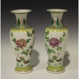 A pair of Chinese famille rose porcelain vases, mark of Kangxi but late 19th century, each of