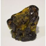 A Chinese reconstituted amber mountain carving, probably 20th century, finely modelled with two