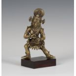 A Sino-Tibetan bronze figure of Mahakala, modelled standing wearing an elaborate skull headdress,