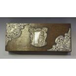An Art Nouveau silver mounted oak rectangular box, the hinged lid applied with an embossed silver