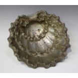 A Continental silver bowl in the form of a stylized scallop shell, raised on winged griffon feet,