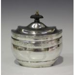 An Edwardian silver oval tea caddy with stepped hinged lid, engraved with Greek key and scrolling