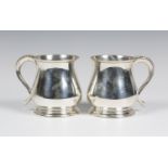 A pair of late 19th century Indian silver tankards, each of baluster form with beaded scroll handle,