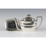 A George III silver teapot and stand with bright cut engraved decoration, the teapot of cushion form