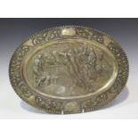 A Continental silver dish of oval form, decorated in relief with a titled scene from Don Quixote, '