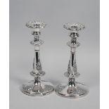 A pair of 19c Sheffield plate double knop chandlesticks, embossed and chased with applied floral and