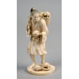 A carved ivory figure of a turtle seller, standing with turtle in left hand together with one in