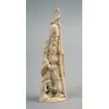 An ivory carving of Jurojin standing with staff, accompanied by a bird, he with seed in his right