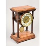 A late 19c German mantel clock by the Hamberg American Clock Co in a walnut portico type case