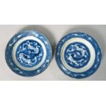 A pair of 19c Oriental blue and white decorated plates with base marks, a/f, 8.5in diam.