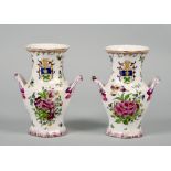 A pair of 18c Strasbourg faience two handled vases painted with scattered flowers and having twig