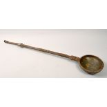 A 19c African steel long handled ladle decorated with simple engraving and with a white metal