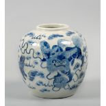 An 18c Chinese pottery jar, blue on white decorated with Dogs of Foe amongst the clouds, character