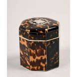 An early 19c tortoiseshell tea caddy of cylindrical octagonal form with a hinged dome cover, with