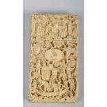 A Japanese Meiji period card case, ivory carved in relief with figures in village settings, 3.25in