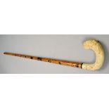 A walking cane painted with commemorative 1940 locations and having a carved bone lion handle, 34.