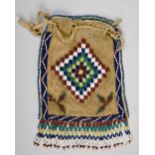 An Early 20c North American leather pouch with drawstring, coloured bead decorated , 7in x 4.5in