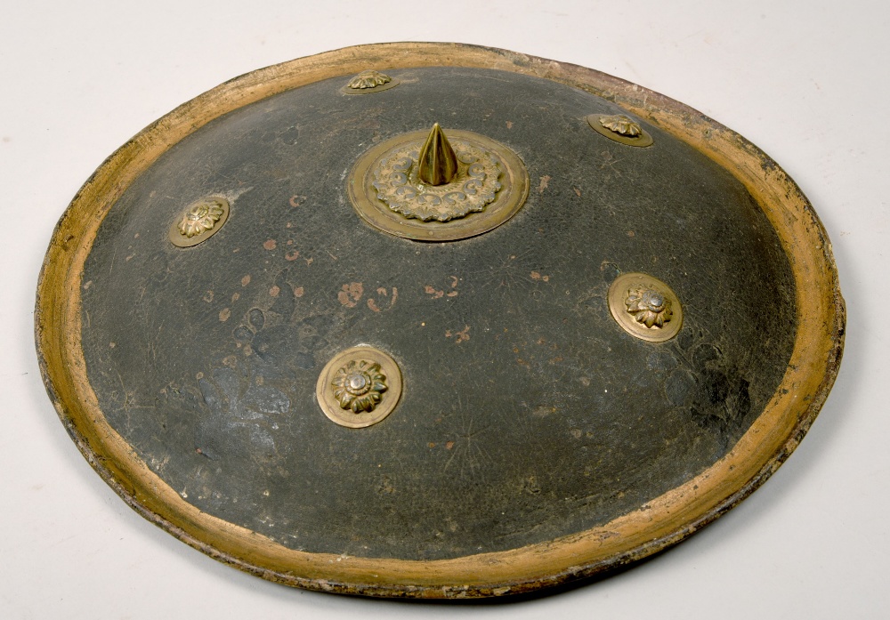 An Indo-Persian painted papier mache shield of circular form with centre spikes surrounded by five