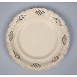 An early 19c creamware serving dish with a wide moulded and pierced outer border, 11.5in diam.