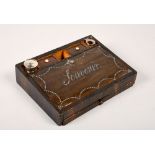 A Victorian rosewood writing box with ink compartments, the hinge cover decorated with polished