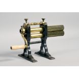 A 19c brass and iron crimping machine, hand operated with turned bone handle and supported on cast