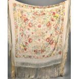 An Edwardian silk shawl with embroidered flowers and fauna throughout, with tassels, 56in sq.