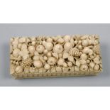 An ivory box in the form of a wicker basket, the lid profusely carved in relief with fruit - hinge