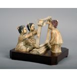 A Japanese carved ivory figure group of two kneeling girls playing a frame of bells observed by a