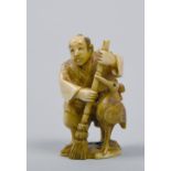 A Japanese carved stained ivory netsuke figure of bird with broom, base signed, Mieji period, 2in