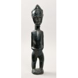 A 19c African carved wood and stained fertility figure, 18in h.