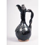 A 19c glazed terracotta pottery ewer jug, moulded and brown glazed with twist form handle, 12.5in