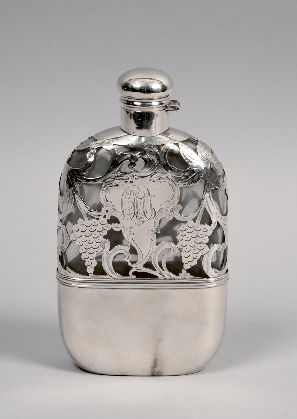 A glass pocket flask with sterling silver fruiting vine cut casing and pull off tot, 6.75in h.