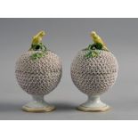 A pair of 19c Meissen Schneeballen bowls and covers, supported on gilt leaf circular stem bases, the