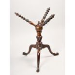 A 19c turned wood 'cat' plate stand, with turned and carved column on tripod legs with pad feet,