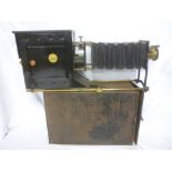 An old brass and painted metal Magic lantern slide projector by Newton & Co in a metal transit case