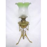 An unusual Art Deco-style brass oil lamp with green tinted glass shade