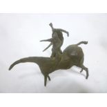 An unusual naive bronze sculpture of two figures on horseback,