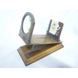 A Victorian walnut folding table viewer with circular magnifying lens on rectangular base