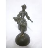 An old bronze figure of a female with basket of flowers,