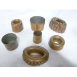 Seven various 19th century copper jelly moulds and pots including two oval geometric jelly moulds,