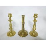 An 18th Century brass ejector candlestick on circular base and a pair of 19th Century heavy brass