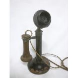 An old painted metal candlestick-style telephone with bakelite ear piece