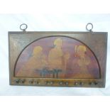 An Edwardian painted and engraved wood wall mounted pipe rack decorated with three male figures